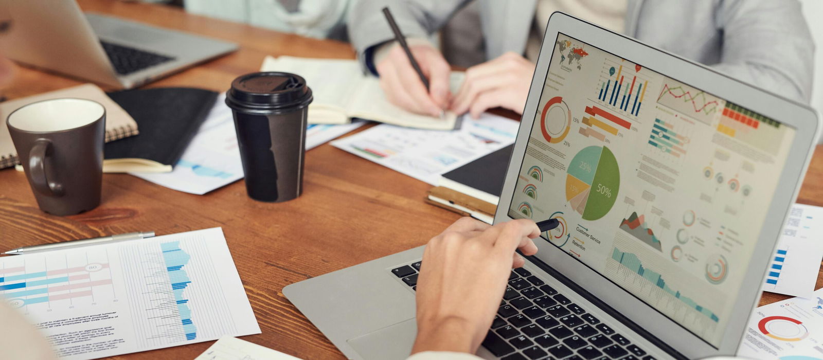 Person looking at meta stats on laptop in meeting